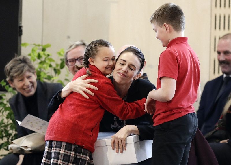 New Zealand Prime Minister Jacinda Ardern embraces a pupil during the opening ceremony for Redcliffs School in Christchurch, New Zealand. The school was rebuilt following earthquakes almost nine years to the day forced pupils and staff from the site. (Photo by Mark Baker/AP Photo)